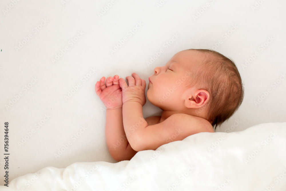 Cute baby boy, peacefully sleeping in bed, covered with white blanket Cute baby boy, peacefully sleeping in bed, covered with white blanket