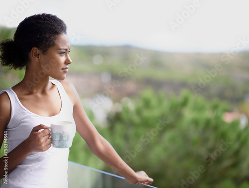 Black woman, thinking and balcony with coffee in relax for morning, breakfast or natural view of neighborhood. Calm African female person or model in wonder with beverage or drink on terrace at home