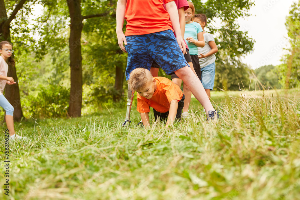 Obraz premium Boy crawling below friend while playing at park