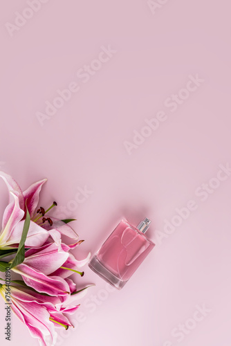 Elegant bottle of cosmetic spray or women s perfume on pastel vertical background with delicate lilies. A copy space. Blank layout for product.