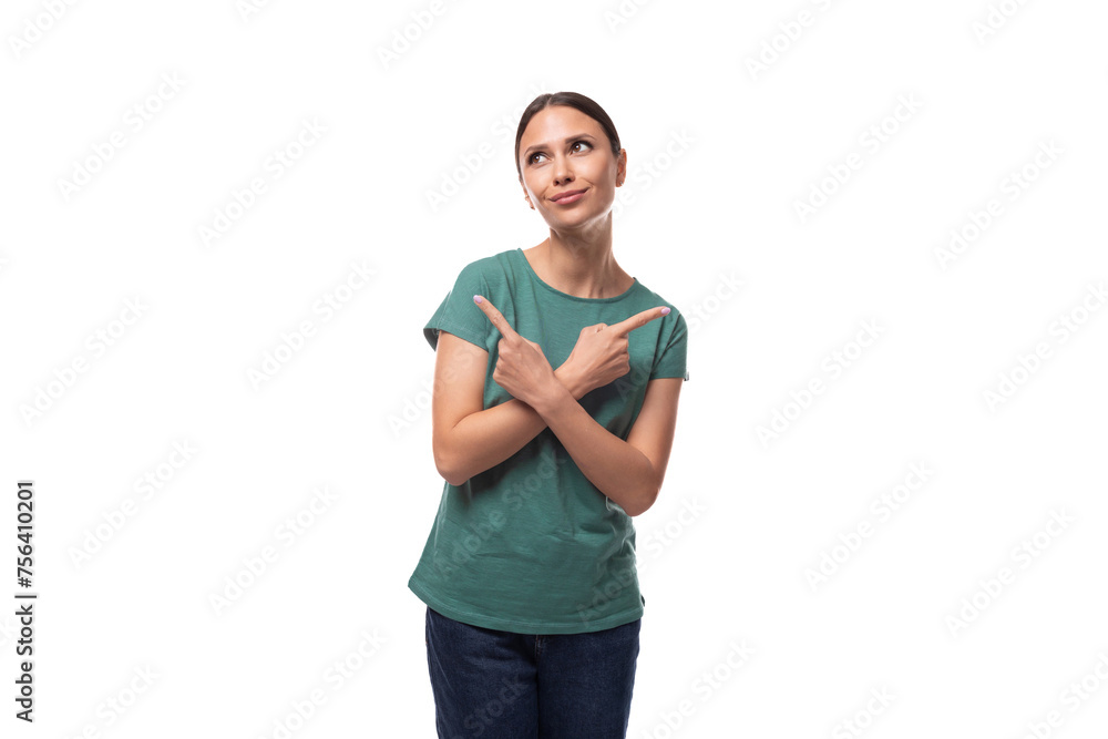 Fototapeta premium young brunette woman in a t-shirt points with her hand to the side on an empty space