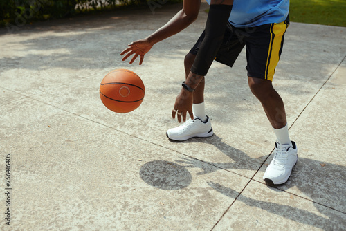 Cropped image of active man playing streetball
