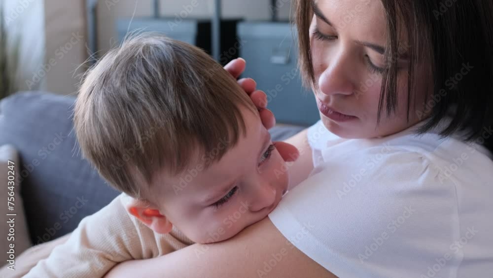 Caring Caucasian mother strokes crying son head, comforting and embracing his. Showing maternity love and care. Helping to cope with stress. Caring Caucasian mother strokes crying son head, comforting and embracing his. Showing maternity love and care. Helping to cope with stress.