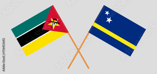 Crossed flags of Mozambique and Country of Curacao. Official colors. Correct proportion
