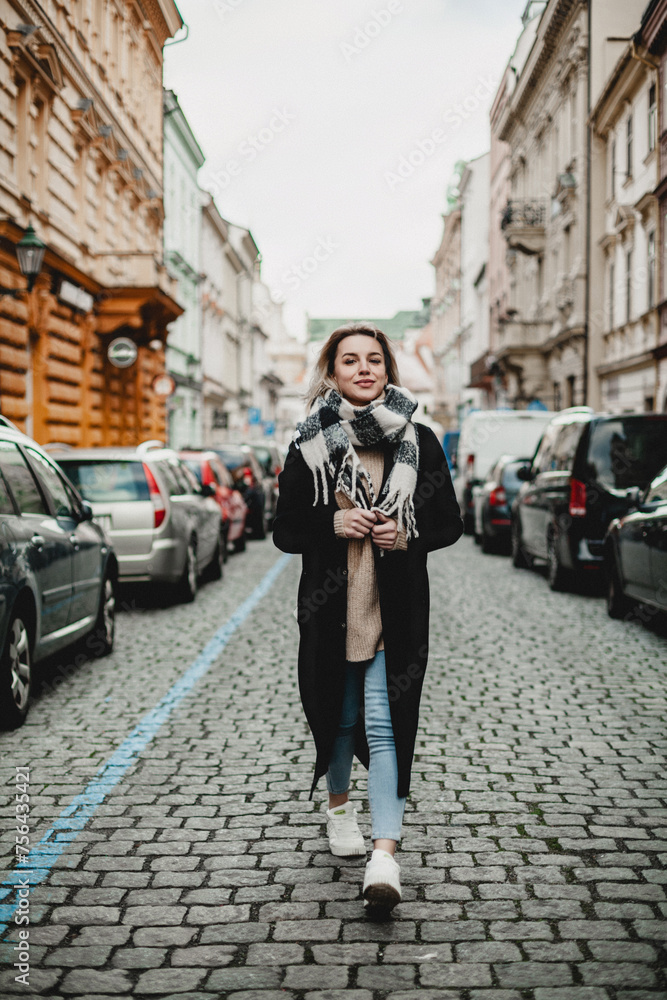 Stylish Woman in Black Coat and Scarf Walking on Cobblestone Street - Urban Fashion, City Lifestyle Concept - Pedestrian in Cityscape with Parked Cars, Winter Scene, Urban Exploration and Fashionable Stylish Woman in Black Coat and Scarf Walking on Cobblestone Street - Urban Fashion, City Lifestyle Concept - Pedestrian in Cityscape with Parked Cars, Winter Scene, Urban Exploration and Fashionable