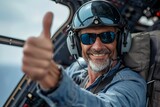 Confident helicopter pilot giving thumbs up from cockpit