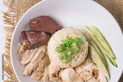 Hainanese chicken rice with soup on dark wooden table background. thaifood concept.