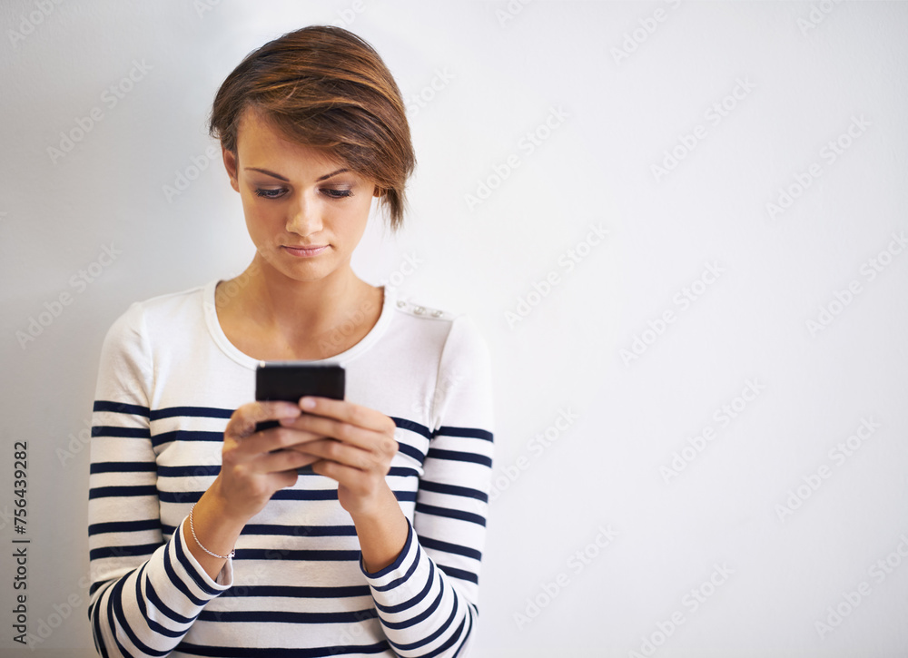 Woman, studio and typing with smartphone, texting or face for social media and communication. Girl, phone and app with technology, online connection or internet message isolated on white background Woman, studio and typing with smartphone, texting or face for social media and communication. Girl, phone and app with technology, online connection or internet message isolated on white background