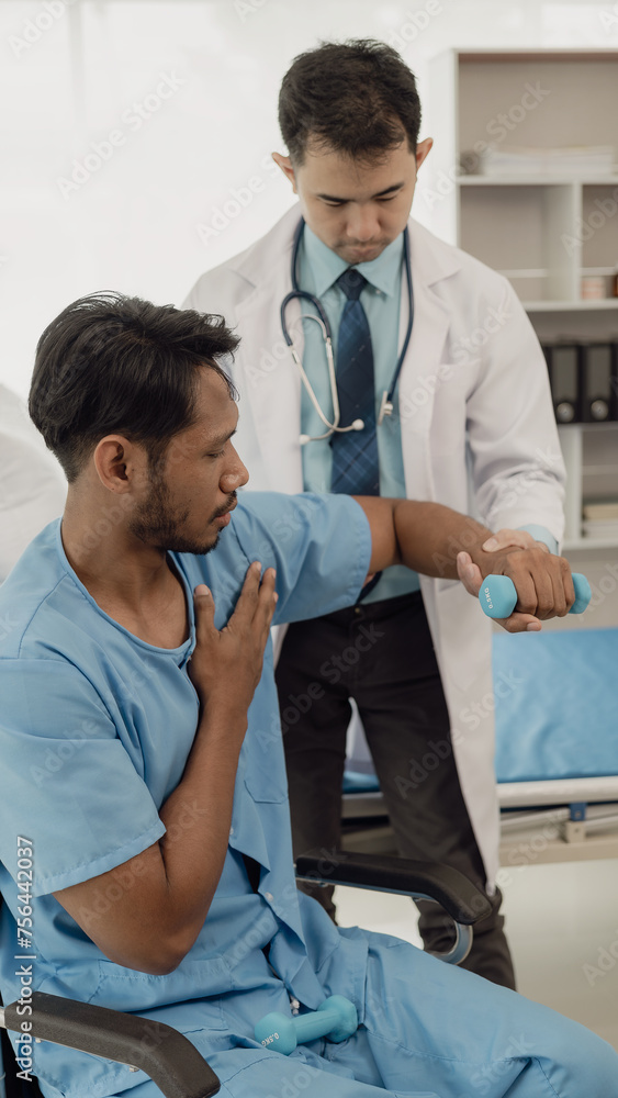 Physical therapist doing physical therapy on male patient with muscle injury in arm, healthy medical treatment concept. Professional male therapist working in rehabilitation center Physical therapist doing physical therapy on male patient with muscle injury in arm, healthy medical treatment concept. Professional male therapist working in rehabilitation center