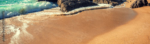 Rocky seascape on a sunny day. View of the rocky beach in Setubal, Portugal. Horizontal banner photo