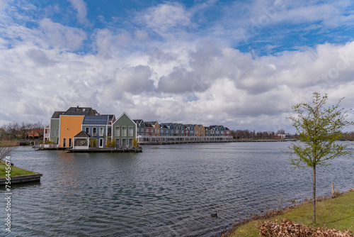 Colourful wooden lakeside houses De Rietplas. Modern residential architecture in Houten, The Netherlands photo
