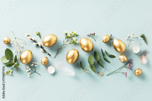 golden quail eggs, feathers and spring flowers