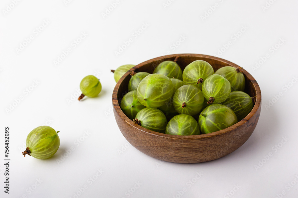 Fresh green gooseberry berries on a white background Fresh green gooseberry berries on a white background