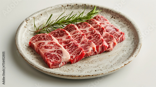 Close up of marble texture of wagyu, Wagyu Beef, Raw beef slice on dish or Japanese style yakiniku food barbecue and grilled over charcoal on stove, Close up japanese A5 wagyu premium beef. 