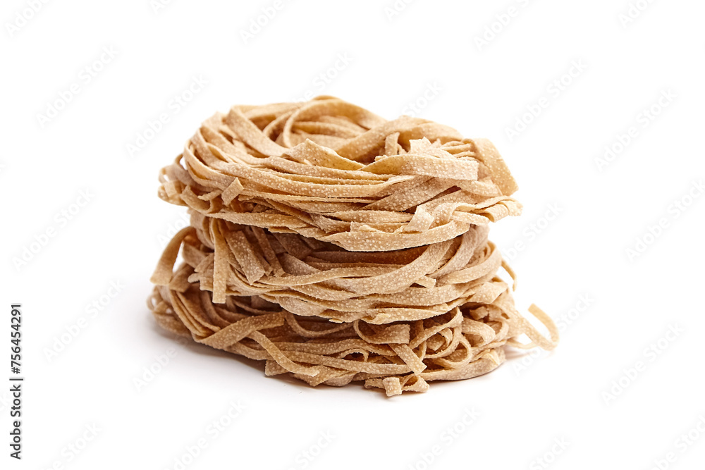 Whole grain pasta tagliatelle isolated on white background. Tagliatelle integrali, wholemeal pasta