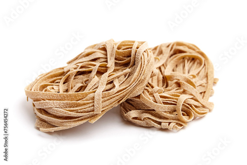 Whole grain pasta tagliatelle isolated on white background. Tagliatelle integrali, wholemeal pasta