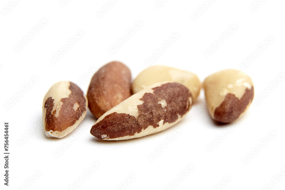 A selective focus image of shelled Brazil nuts isolated against a white background A selective focus image of shelled Brazil nuts isolated against a white background