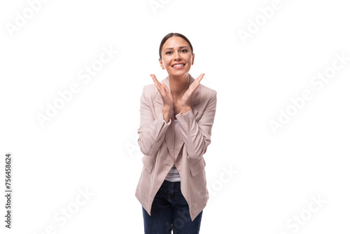 young positive caucasian woman with a ponytail hairstyle dressed in a jacket laughs on a white background