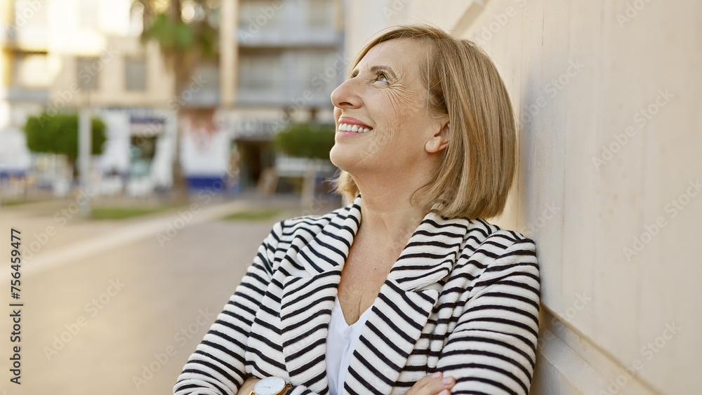 Caucasian senior woman smiling outdoors in an urban setting wearing stripes