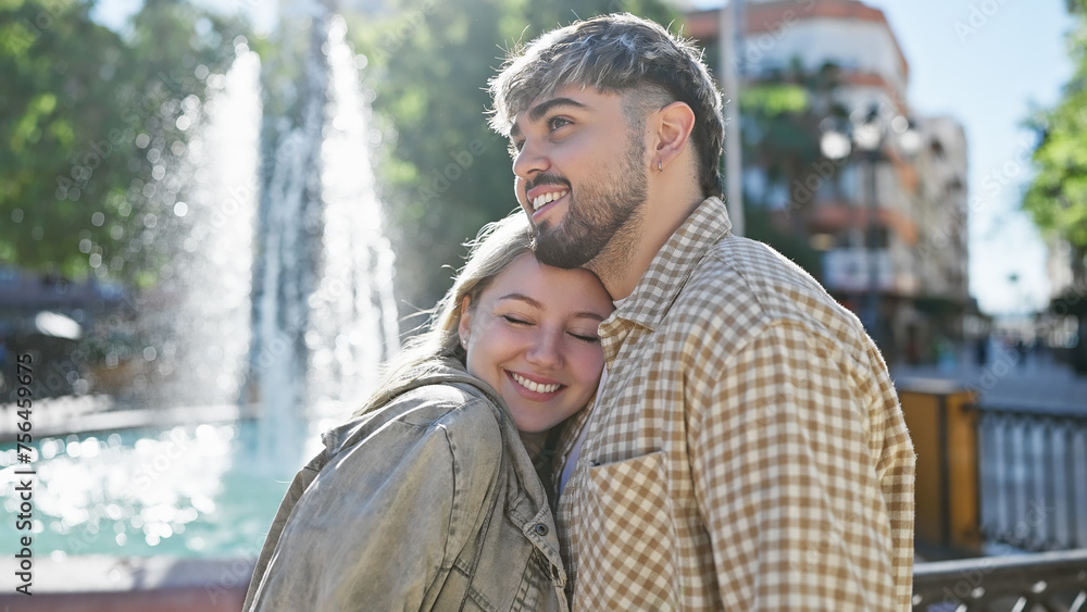 Loving couple embracing outdoors near a city fountain, reflecting happiness and romantic relationship in a sunny urban park. Loving couple embracing outdoors near a city fountain, reflecting happiness and romantic relationship in a sunny urban park.