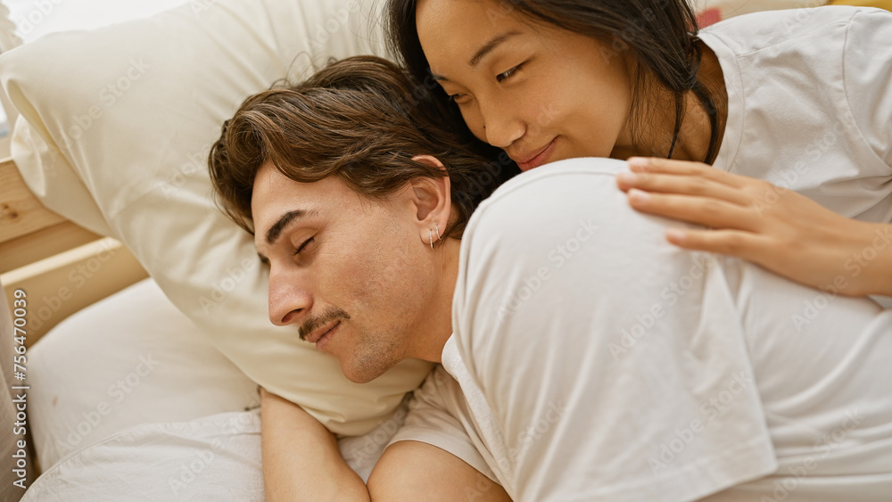 A loving interracial couple cuddling in a cozy bedroom setting, portraying warmth and affection.