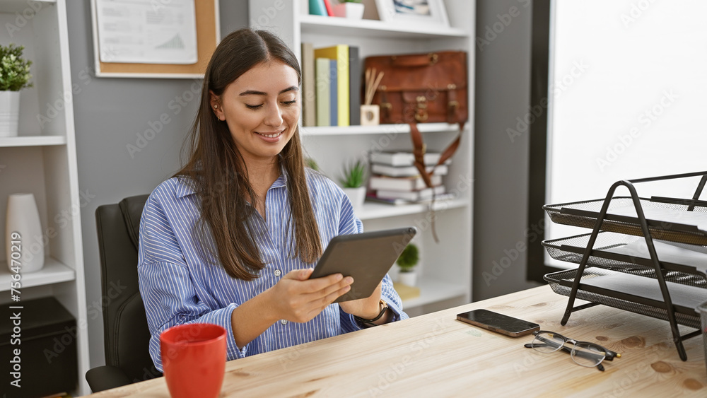 A smiling woman reading a tablet in a modern office setting, exemplifying professionalism and approachability. A smiling woman reading a tablet in a modern office setting, exemplifying professionalism and approachability.