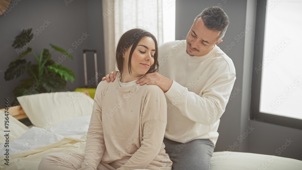 A loving couple enjoys a serene moment together in the comfort of their modern bedroom, portraying family intimacy and care. A loving couple enjoys a serene moment together in the comfort of their modern bedroom, portraying family intimacy and care.