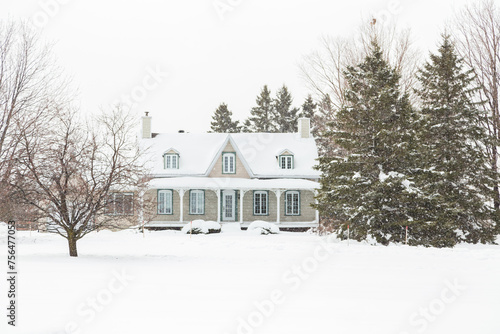 Cuadro en lienzo Pretty clapboard house with porch, gable and dormer windows seen during a heavy
