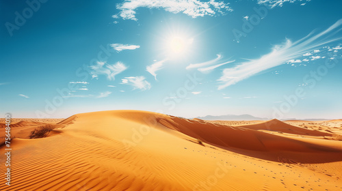 Scenic view of vast desert dunes with patterns of wind-swept sand under a bright sun in a cloud-dappled blue sky.