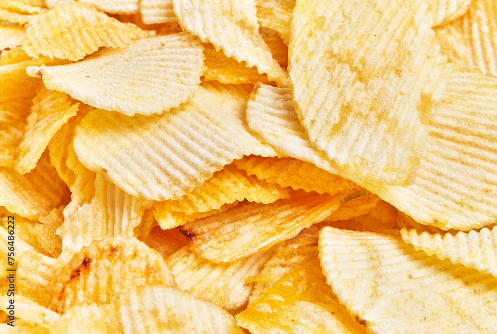 Close-up view of crispy, golden potato chips filling the frame, epitomizing snack and indulgence. Close-up view of crispy, golden potato chips filling the frame, epitomizing snack and indulgence.