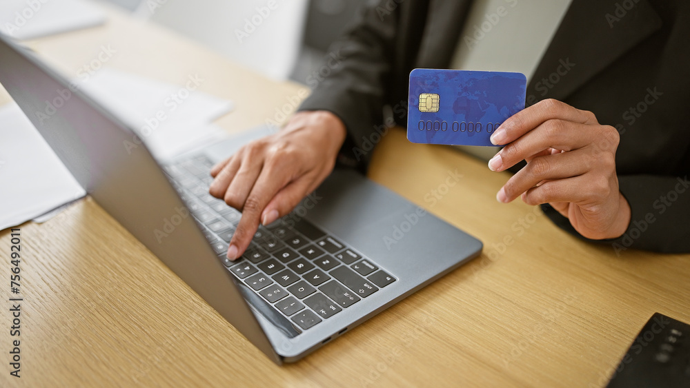 Hands of woman business worker using laptop and credit card at the office Hands of woman business worker using laptop and credit card at the office