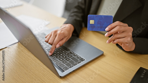 Hands of woman business worker using laptop and credit card at the office