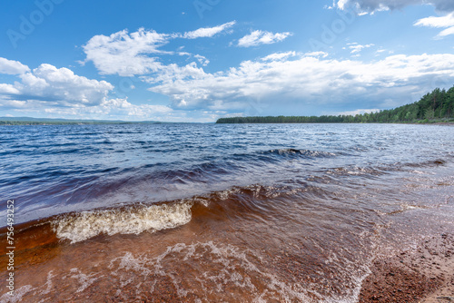 Summer view from a sandy beach in a lake in Sweden