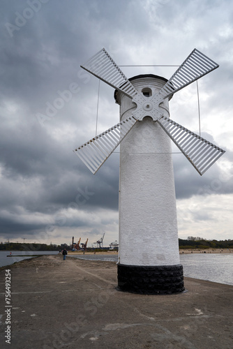 breakwater with a navigation sign in the shape of a windmill on the Baltic Sea in the city of Swinoujscie
