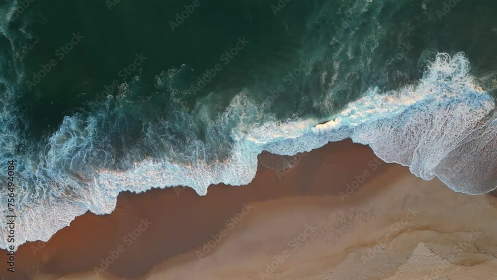 Powerful ocean wave over sand beach. Aerial top down view of sea surf on the beach Powerful ocean wave over sand beach. Aerial top down view of sea surf on the beach