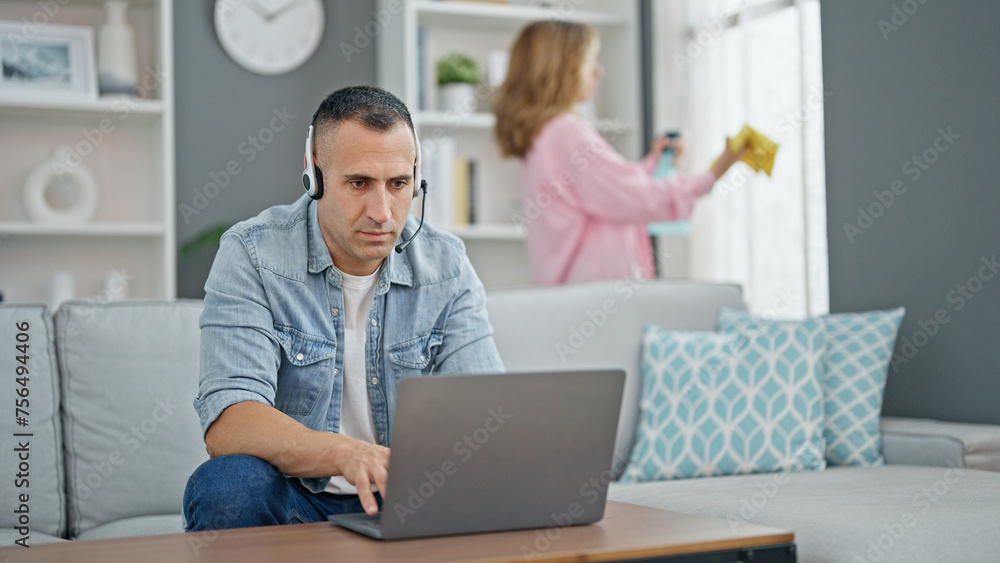 Man and woman couple doing chores while work at home Man and woman couple doing chores while work at home