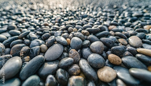 seamless dark black pile of small stone pebbles background texture beautiful shiny zen gravel river rocks widescreen wallpaper repeat pattern high resolution nature closeup abstract 3d rendering