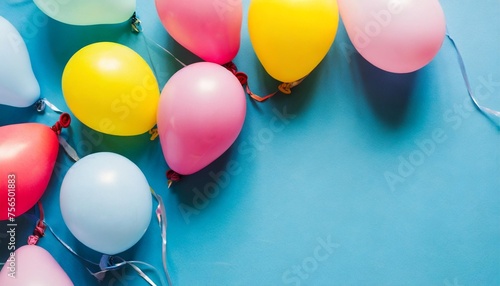 colorful balloons on blue background with copy space flat lay
