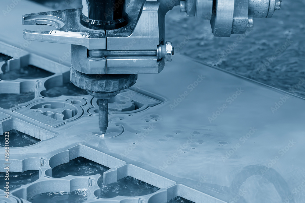 The abrasive waterjet cutting machine cutting the metal plate in the light blue scene. The abrasive waterjet cutting machine cutting the metal plate in the light blue scene.