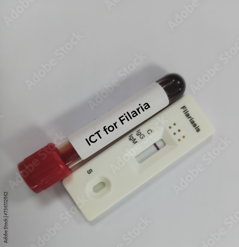 Blood sample and rapid test kit for Filaria test showing negative result at white background. Filariasis. photo