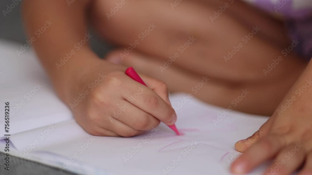 Close-up of little girl's hand with pencil. Five year old girl drawing at home after kindergarten. Red pencil Close-up of little girl's hand with pencil. Five year old girl drawing at home after kindergarten. Red pencil