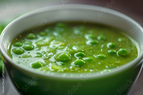 A bowl of green pea soup, closeup