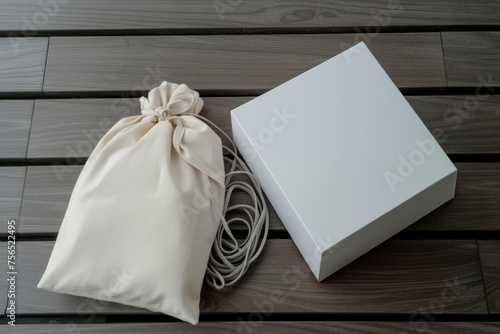 gift wrapping mockup fabric pouch mockup and white box mockup, elegant mockup packing cord, luxury packaging on wooden background.