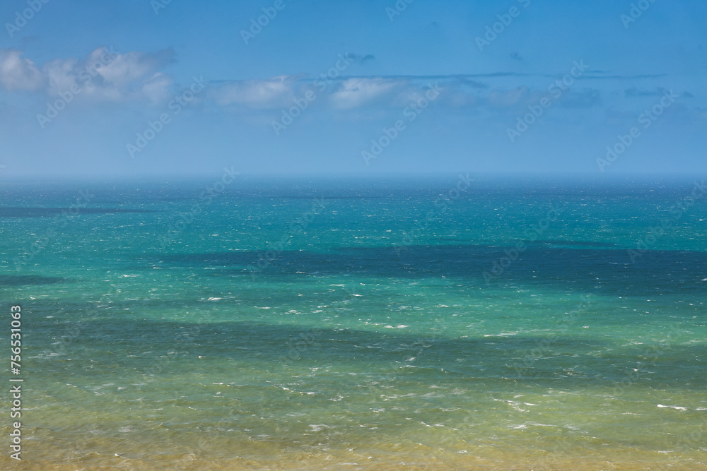 Obraz premium Atlantic Ocean. Photo with the beautiful green blue water landscape of the ocean, the layers of water, during a sunny day at Cabo da Roca in Portugal.