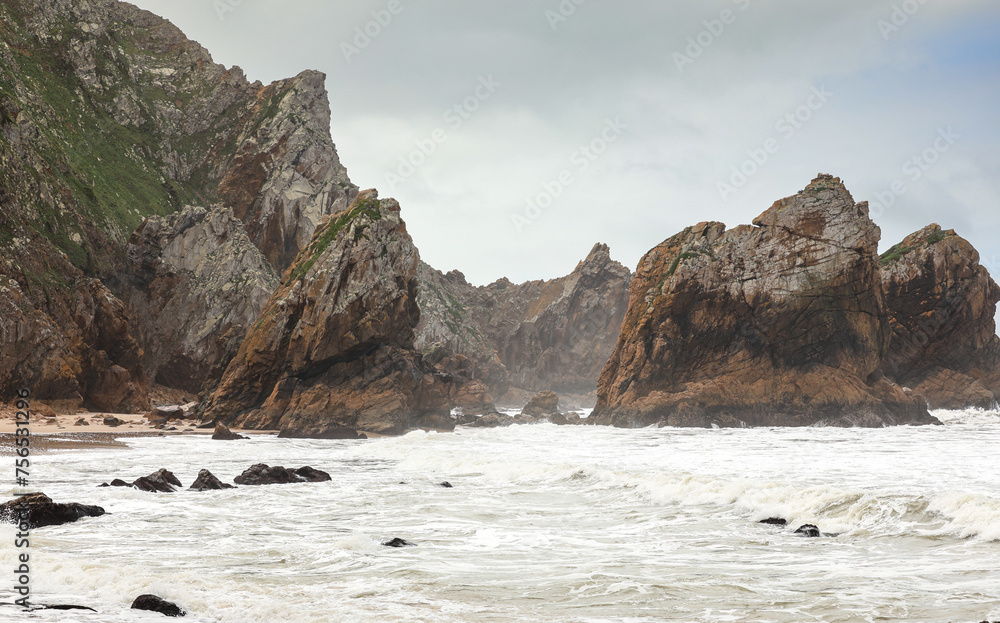 Ursa Beach, also known as Praia da Ursa in Portuguese, in a photo during a cloudy day at Cabo da Roca. swirling Atlantic ocean with strong big waves. Travel to Portugal.