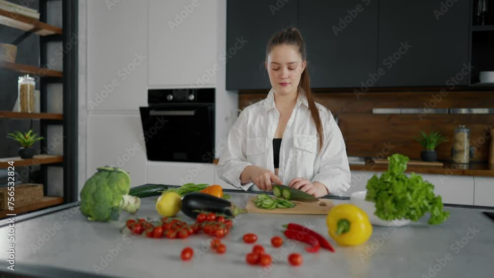 Young woman cooking salad at kitchen. Girl cook organic natural ingredients vegan healthy food in modern kitchen. Attractive girl cutting vegetables, weight loss, healthy cooking salad at home. Young woman cooking salad at kitchen. Girl cook organic natural ingredients vegan healthy food in modern kitchen. Attractive girl cutting vegetables, weight loss, healthy cooking salad at home.