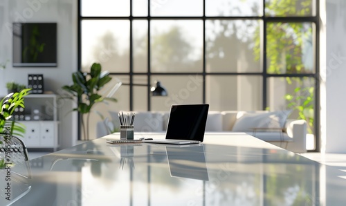 A modern laptop computer is placed on a sleek glass table in a wellfurnished living room, adorned with plants and overlooking a scenic view through a window photo