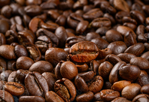 Scattered fragrant roasted arabica coffee beans close-up