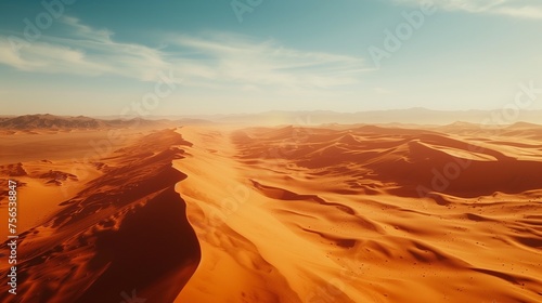 A vast desert landscape with towering red sand dunes stretching as far as the eye can see.