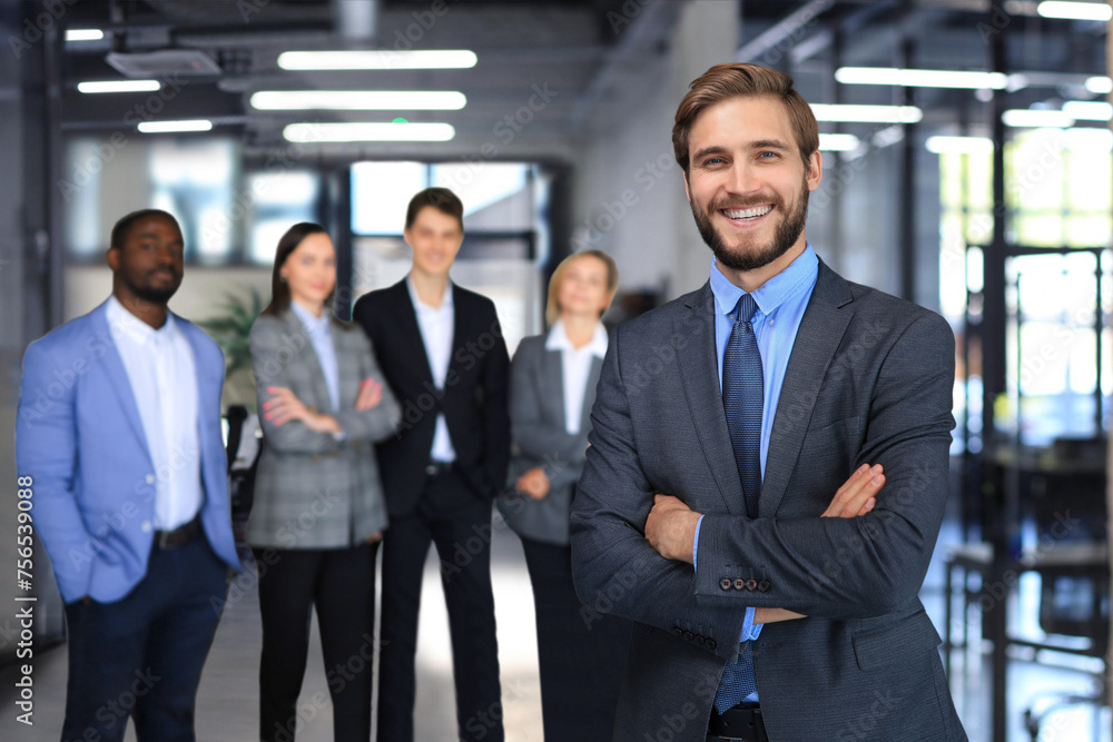 Businessman with colleagues in the background in office. Businessman with colleagues in the background in office.
